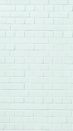 a white brick wall that is painted green