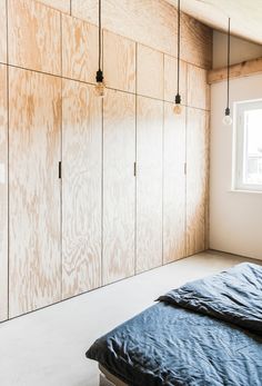 an empty bedroom with wood paneling on the walls