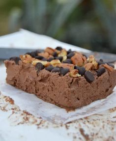 a piece of chocolate cake with nuts on top