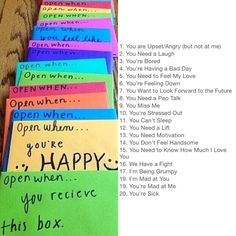 several colorful notes are lined up on a wooden table with the words open when you're happy