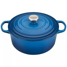 a blue casserole with a lid and handle on it's side, sitting in front of a white background