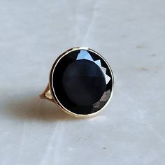 ITEM DESCRIPTION: >>The ring is made from Solid 14K Yellow Gold. >>Gemstone used is absolutely natural and ethically sourced. >>Natural Flat Cut Black Onyx in round shape and bezel setting is studded on it with utmost precision. Gem: Black Onyx Gem size & shape: 20x20 mm and Round Gem weight: 9.05 Carats Gold purity: 14K (58.33% approx.) Gold weight: 2 grams Gross weight of ring: 3.81 grams The Gold purity is guaranteed and it comes with authentic 14K gold hallmark. Since these Rings are handmad Faceted Round Onyx Jewelry, Classic Black Oval Sapphire Ring, Classic Black Sapphire Oval Ring, Black 14k Gold Jewelry With Bezel Setting, Black Sapphire Ring With Polished Finish For Anniversary, Formal Black Sapphire Ring In 14k Gold, Formal Black Sapphire Ring With Polished Finish, Anniversary Black Sapphire Ring With Polished Finish, Black Round Ring With Bezel Setting