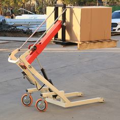 a red and white cart sitting in the middle of a parking lot next to boxes