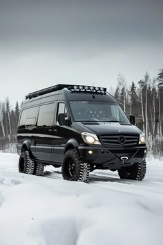 a mercedes benz van driving through the snow