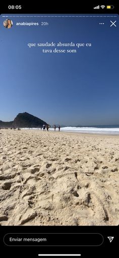 a beach with people walking on the sand