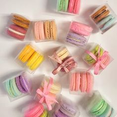 there are many different colored macaroons in the box