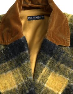 The rich yellow hue adds a vibrant touch to your ensemble, complemented by exquisite logo details and a button closure. Color: Yellow Material: 27% Angora, 26% Polyester Film Fiber, 21% Wool, 10% Nylon, 8% Virgin Wool, 8% Mohair Country of origin: IT Designer Gold Single Breasted Outerwear, Designer Gold Single-breasted Outerwear, Classic Yellow Outerwear With Lapel Collar, Classic Yellow Blazer With Button Closure, Blazer And Skirt, Long Trench, Long Trench Coat, Sunny Yellow, Dolce E Gabbana