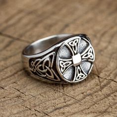 a silver ring sitting on top of a wooden table