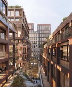 people are walking through an open courtyard in a building with many windows and balconies