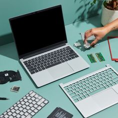 an open laptop computer sitting on top of a desk next to other electronic components and gadgets