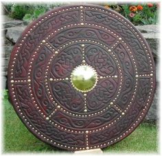 a large round metal object sitting in the grass