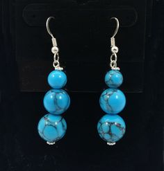 Up for sale is a pair of Custom Turquoise Round/Globe Beads & .925 Sterling Silver Fish Hook Dangle Earrings. Sale is for earrings shown in photos. .925 Sterling Silver may have some light tarnishing. Please see last photo for size comparison. We have lots of other Turquoise earring styles available. Rabbask Designs is a small business located in Loveland, Colorado. We have art works for sale from over 100 local artists and have an eclectic mix of vintage and handmade jewelry, fine art, shoe Blue Round Beads Pierced Earrings, Blue Pierced Earrings With Round Beads, Turquoise Round Beads Earrings For Gift, Turquoise Hypoallergenic Beaded Drop Earrings, Hypoallergenic Turquoise Beaded Earrings, Turquoise Sterling Silver Hypoallergenic Beaded Earrings, Hypoallergenic Turquoise Beaded Earrings In Sterling Silver, Hypoallergenic Turquoise Beaded Dangle Earrings, Loveland Colorado