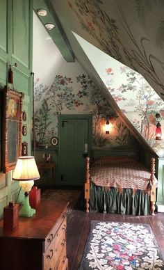 an attic bedroom with green walls and floral wallpaper