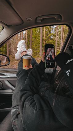 someone taking a selfie in the back seat of a car with their cell phone