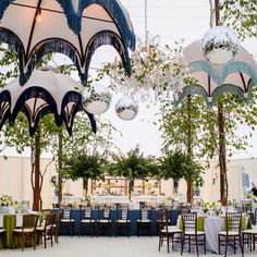 the inside of a tent with tables and chairs set up for an outdoor function or party