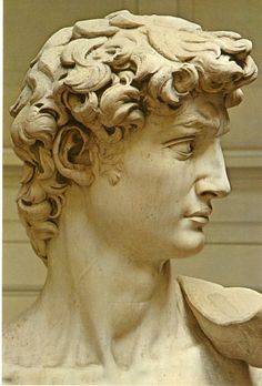 a close up of a statue of a man's head with curls on his hair