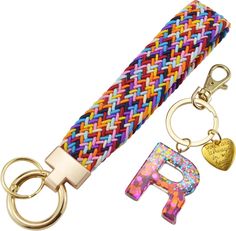 two keychains with different colors and designs on one side, the other has a letter