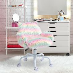 a white desk chair sitting in front of a pink brick wall next to a dresser