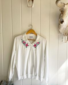 "Vintage Anthony Richards Long Sleeve Collared Flower Embroidered Shirt. Cotton/Poly. Elastic cuffs and waist. Blue, violet, pink, and green flowers on white. Two small stains on the back of the collar. Size: XL. Length: 24.5\" Underarm to Underarm: 23\". Orders over $35 ship for free. Please check out my Instagram for my newest finds: Hollyshopvintage Most items are Vintage. Expect some vintage wear. I only post items that have a lot of life left. I do my best to accurately describe each item. Pink And Green Flowers, Richard Long, New Braunfels, Blue Violet, Womens Blouses, Vintage Wear, Embroidered Shirt, Green Flowers, Floral Shirt