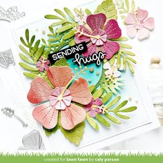 a close up of a card with flowers and leaves on the bottom, along with words saying sending hugs