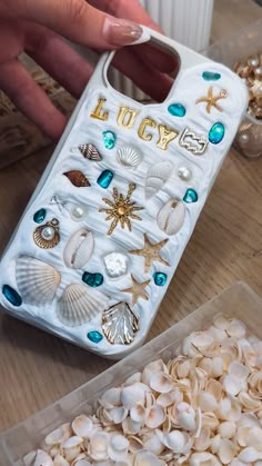 there is a cell phone case that has shells and seashells on the back