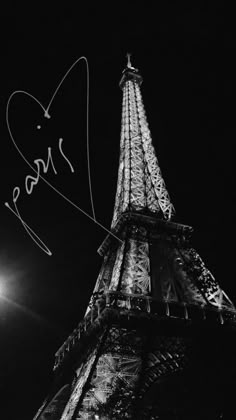 the eiffel tower is lit up at night with autographs written on it