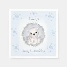 a birthday card with a white teddy bear in a wreath and snowflakes on the background