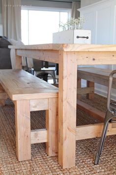 a wooden table with two benches underneath it