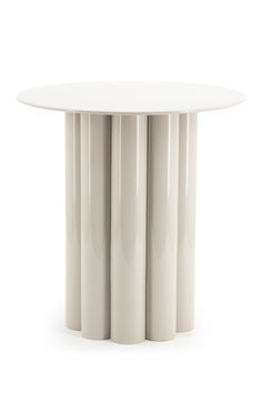 a white round table with four columns on the top and one column at the base