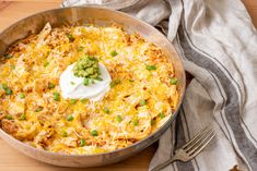 a casserole dish with sour cream and green onions