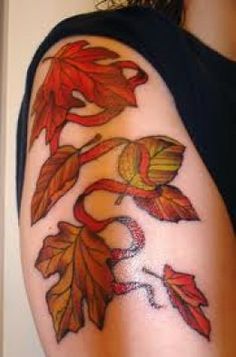 a woman's arm with leaves on it