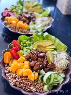 two bowls filled with different types of food on top of a table next to each other