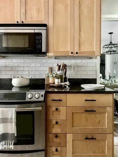 a kitchen with wooden cabinets and stainless steel appliances