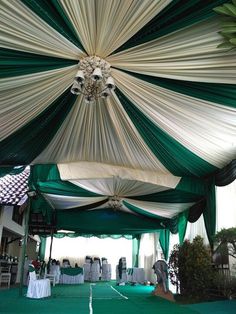 a tennis court covered in white and green drapes