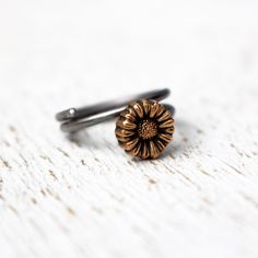 Adjustable floral sunflower ring to wear as knuckle ring, toe ring or as a regular ring on any finger. The tiny flower is made in bronze and the adjustable ring band in stainless steel. Both bronze and steel are strong hard metals and this makes a very durable design. MADE ON DEMAND, takes me up to 7 workdays to complete. Here you find other designs with flowers https://www.etsy.com/se-en/shop/AnnaSiivonen?ref=seller-platform-mcnav&search_query=flower Dainty Adjustable Hand Forged Stackable Rings, Dainty Hand Forged Adjustable Stackable Rings, Adjustable Nickel-free Flower Ring For Promise, Dainty Adjustable Stackable Metal Rings, Adjustable Nickel-free Flower Promise Ring, Adjustable Brass Midi Rings In Dainty Style, Adjustable Metal Flower Ring With Open Design, Adjustable Flower Shaped Metal Ring, Minimalist Adjustable Toe Flower Ring