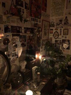 a cluttered room with lots of plants and pictures on the wall, including a clock