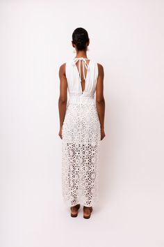 Introducing the stunning Lin White Crochet Maxi Dress! Featuring delicate crochet lace and a deep V front bodice, this dress is sure to make a statement. The modesty lining ensures comfort and coverage, while the rear neck ties add an extra touch of elegance. Don't miss out on this must-have piece for your wardrobe! 100% Cotton. Hand wash. Lace Maxi Dress With Lace Trim For Brunch, Lace Crochet Dress With Scalloped Lace For Brunch, Elegant Beach Dress With Lace Top, Elegant Lace Top Beach Dress, Spring Lace Maxi Dress With Lace Top, Lace Maxi Dress With Lace Top For Spring, Maxi Length Crochet Dress With Lace Trim, Elegant Dresses With Delicate Cotton Lace, Elegant Lace Dresses With Delicate Details