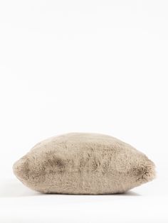 a pillow that is on top of a white surface