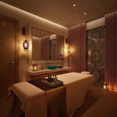 a spa room with candles lit up on the walls