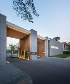 the entrance to an office building with wooden doors and lights on it's sides