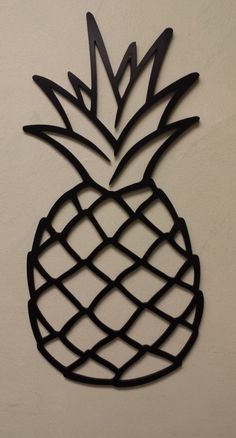 a metal pineapple on a white wall