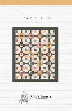 the star tiles quilt pattern is shown in front of a white brick wall and it's black border