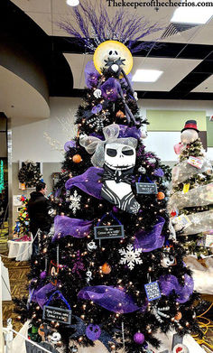 a decorated christmas tree in the middle of an office cubicle with purple and white decorations