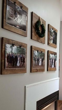 a fireplace with pictures on the wall above it and wreaths hanging from the mantel