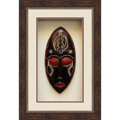 an african mask with red eyes in a brown frame