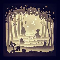 paper cut art depicting cats in the woods at night with moon and stars above them