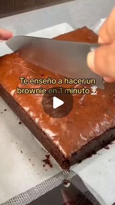 someone cutting into a brownie with a knife on top of it and the words, te enseno a hacer un brownie en 1 minuto