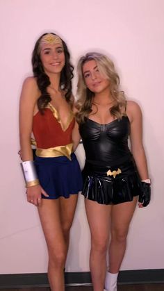 two women dressed up in costumes posing for the camera