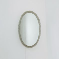 a round mirror mounted to the side of a wall