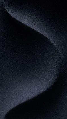 an abstract black background with smooth lines and curves in the center, as well as dark colors